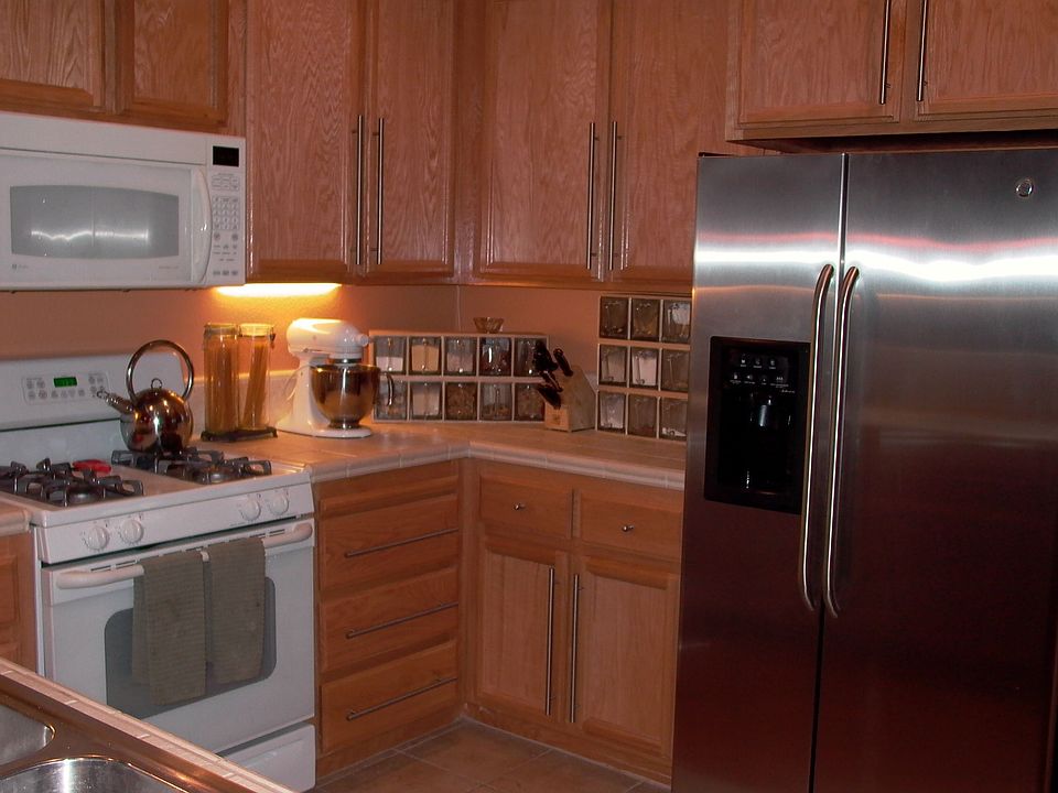 stainless fridge is included, custom handles, upgraded tile top