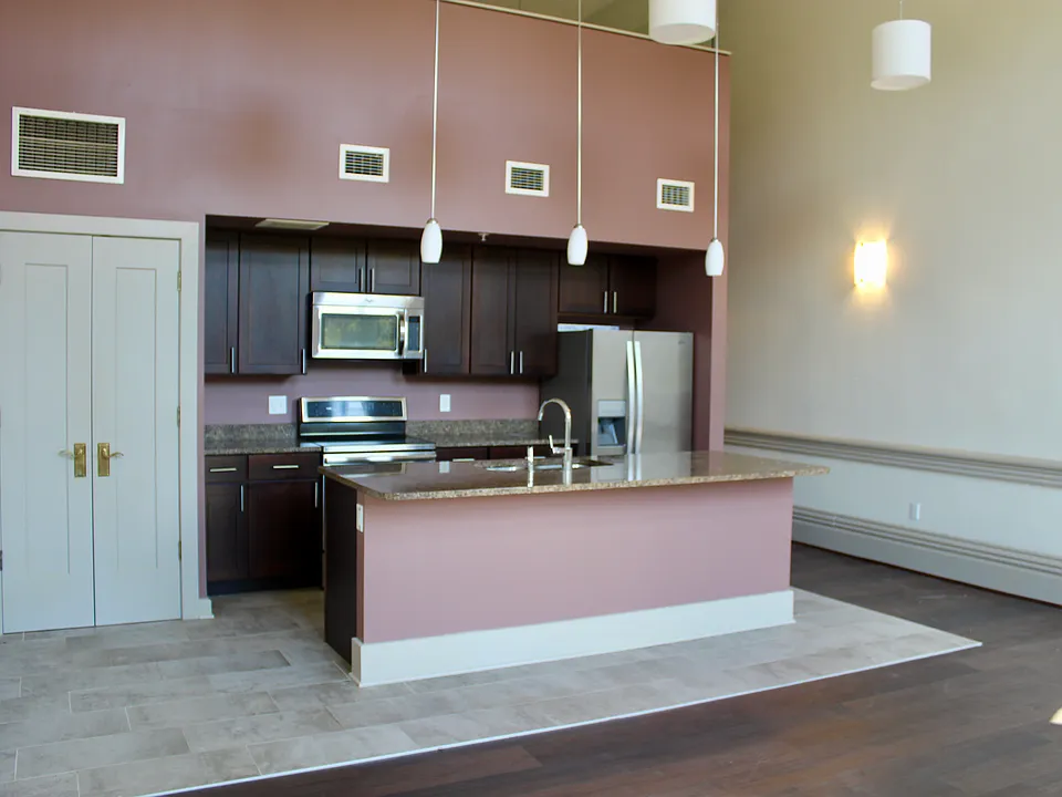 A modern kitchen with closet/pantry and island