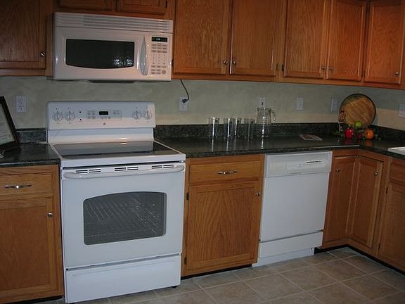 Kitchen - new range, microwave, custom countertop, new sink, tile floor