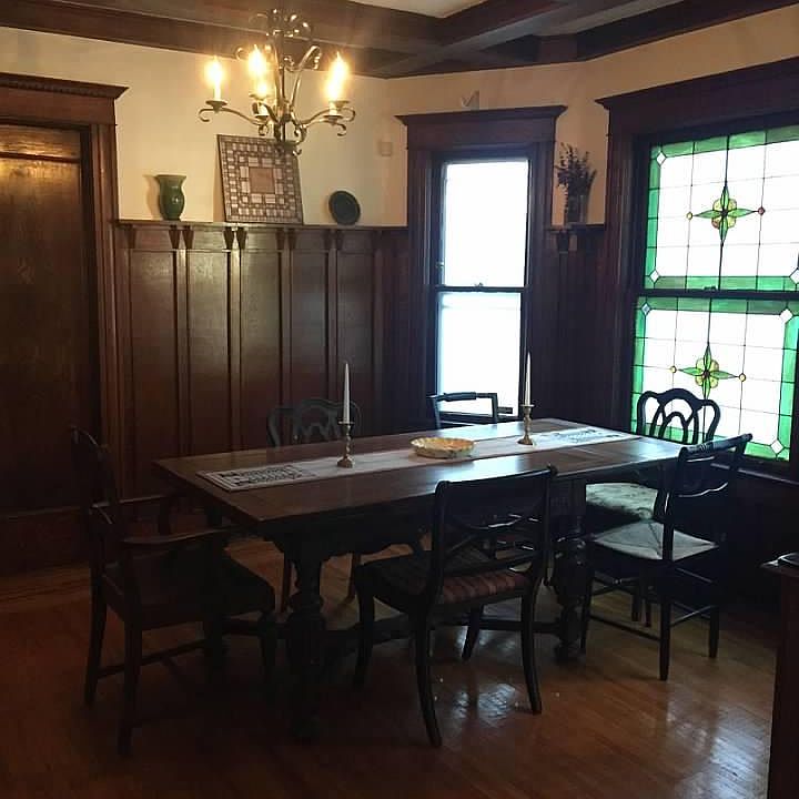 Dining room with original woodwork and stained glass windows