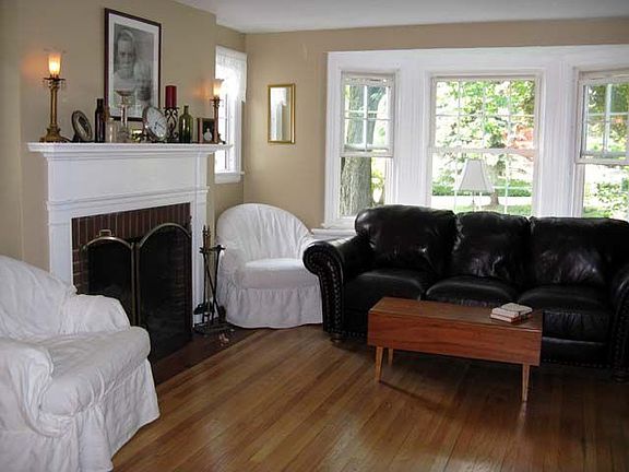 Living room has a fireplace and a bay window.
