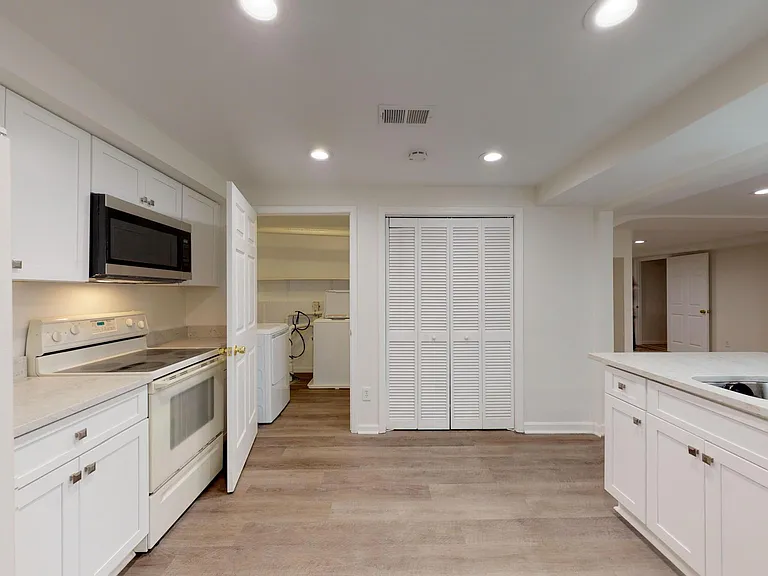 Another view of kitchen from private entry door. New washer/dryer in laundry room can be seen on left