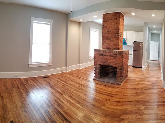 Wide angle view from living room with bedroom door visible at opposite end.