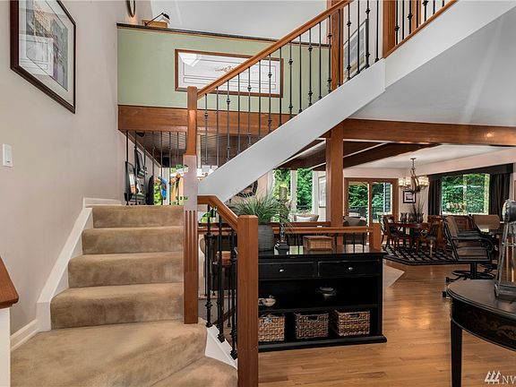 Inviting entry with stunning architectural details like this open wrought iron staircase.