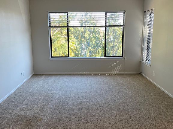 Large living room with plenty of light and pretty green view