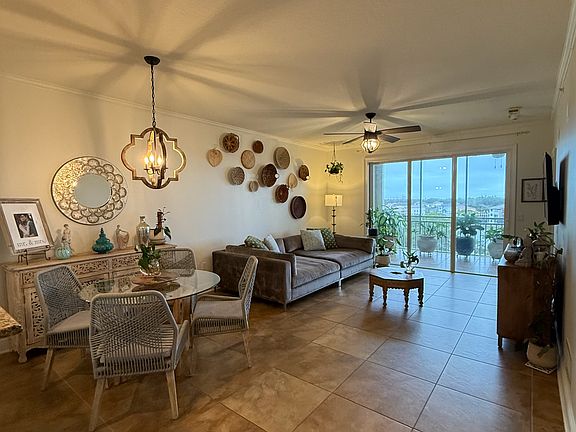 Main living space with access to lanai and expansive waterfront views.