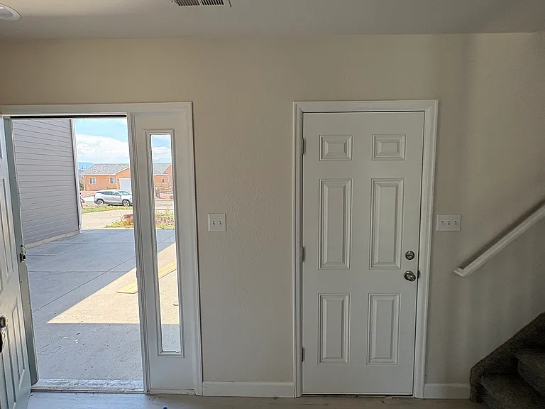 front door with spacious front entry. also entry into spacious two car garage