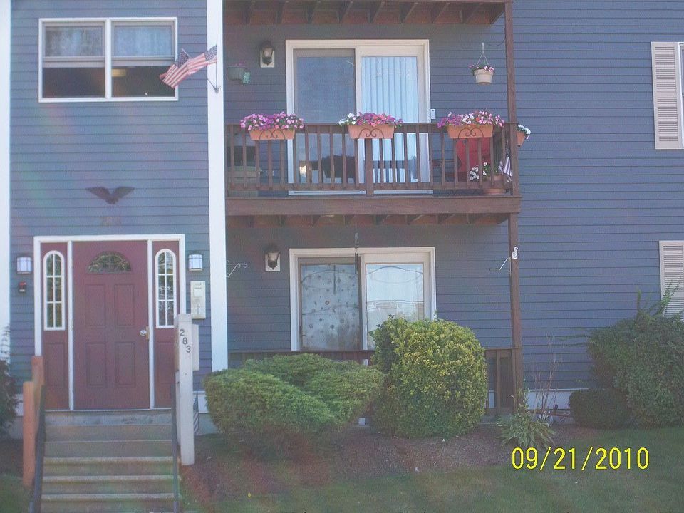 Front Balcony Of Unit With Flower Pots & Flag