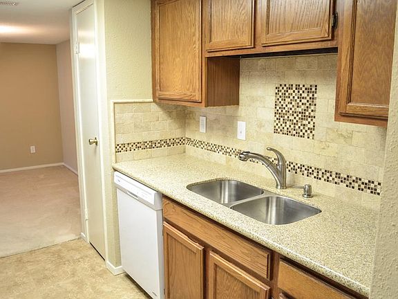 Travertine backsplash with glass mosaic accents