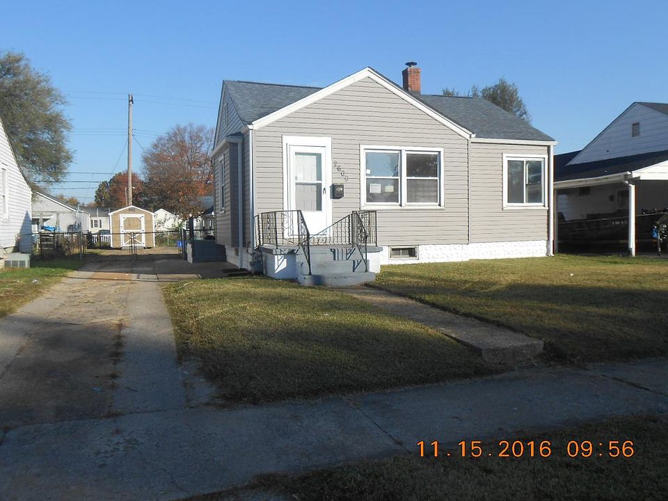 Long driveway with large shed