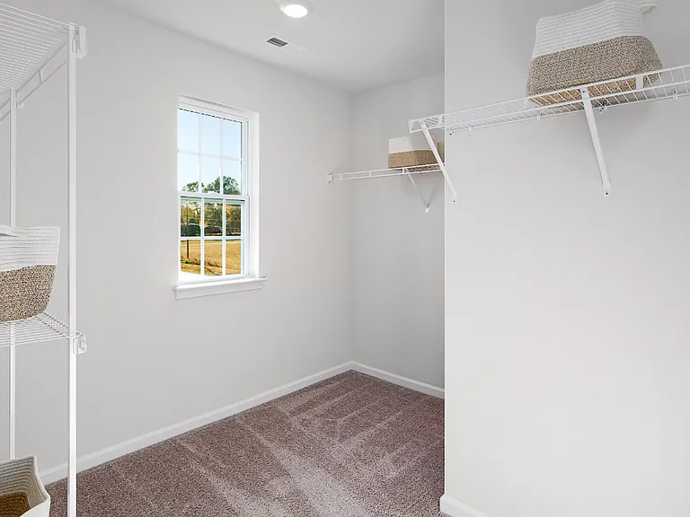Primary Closet. Photos are builder provided and do not reflect current furnishings or finishes.