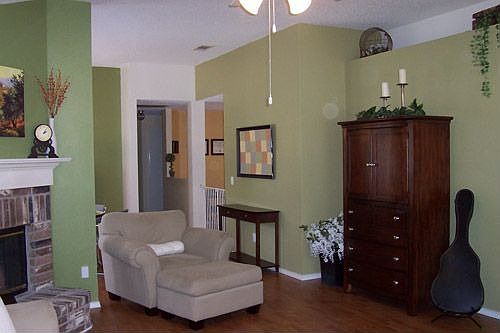 The living room's vaulted ceilings also make way for a cute plant shelf.