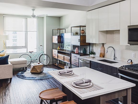 Moveable kitchen islands with storage and hardwood-inspired plank-style flooring