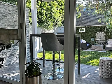 Outdoor dining table in front of fireplace