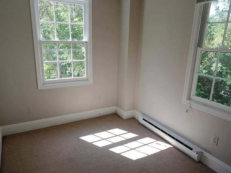 Originally a screened in porch, this small room off the dining room would make a perfect office, nursery or hideaway. Built-in shelves and cabinets on opposite wall.