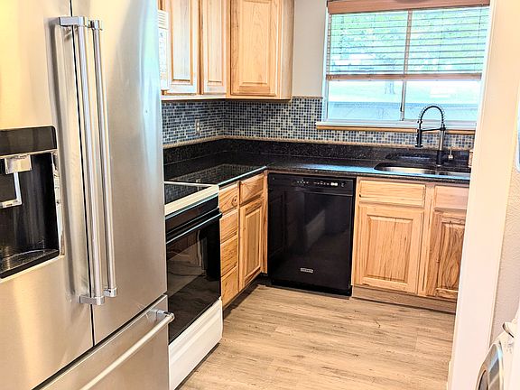 Kitchen with black granite countertops