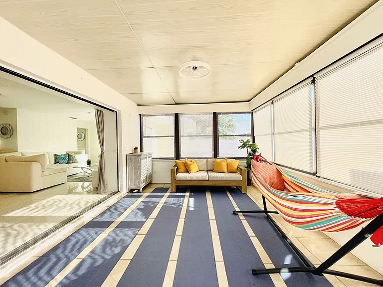 Florida room is connecting the main living room to the outside patio area.