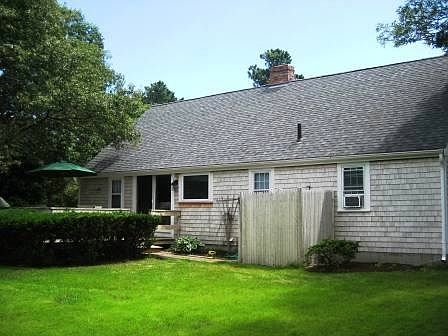 View of back of home with outdoor shower