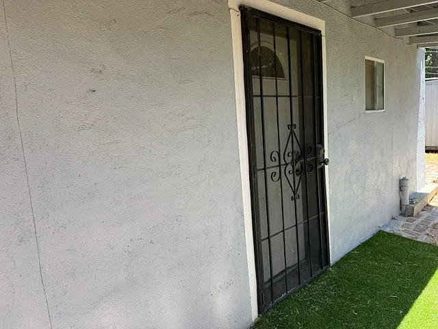 FRONT ENTRY WITH SECURITY DOOR AND FAUX GRASS
