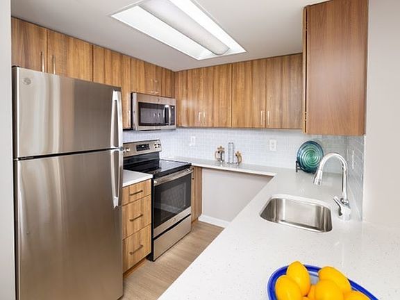 Renovated Apartments With Quartz Countertops, Energy Efficient Stainless Steel Appliances and Wood-Style Flooring Throughout Kitchen and Living Areas
