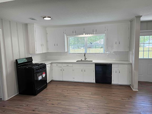 Kitchen with new granite countertops, new backsplash, new sink, new range, new dishwasher