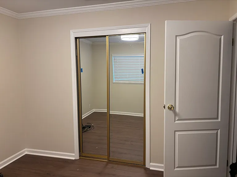 Bedroom 2 with mirrored closet doors