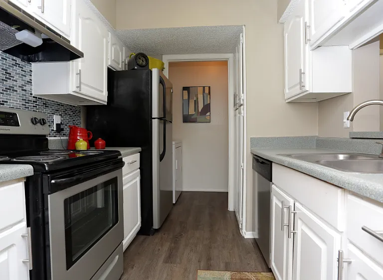 Apartment kitchen with stainless style appliances and spacious countertops