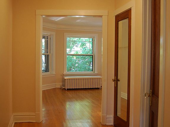 Entry Foyer looking into Living Room. Hall closet with mirror.