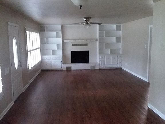 The Living Room, Fires are not allowed in the fire place. The photo is taken from the kitchen through the Dinning area and into the Living Room.