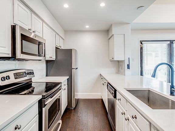This is kitchen view with a brand new refrigderator with a open sink concept as part of the remodel. I ran the hardwood floors through the kitchen area and really, really like how they turned out and had good continuity throughout the condo!