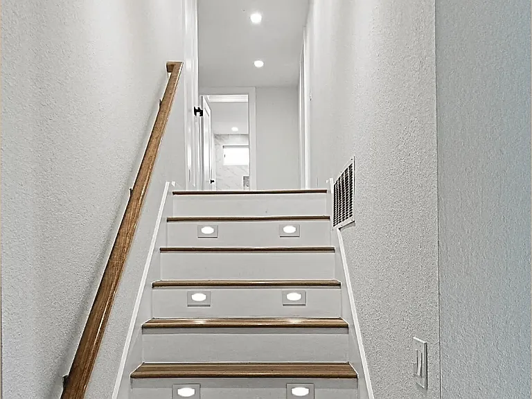 Staircase to upper floor leading to 3 upstairs bedrooms
