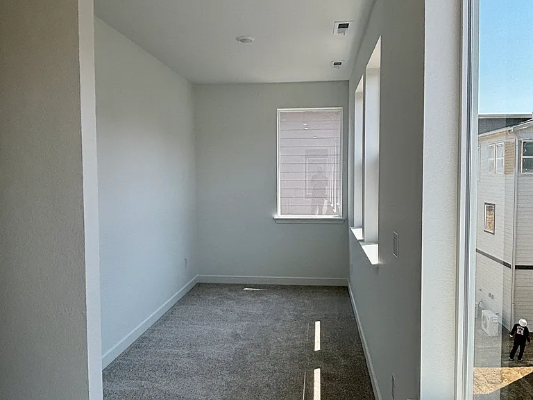 upstairs area for electronics or workout with brilliant light from the wall of windows