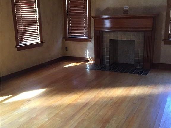 Look at the beautiful wood floors and fireplace in living.  Also notice the wood blinds.