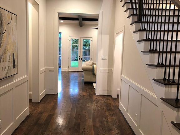 Welcoming foyer with custom wainscoting and wine bar.