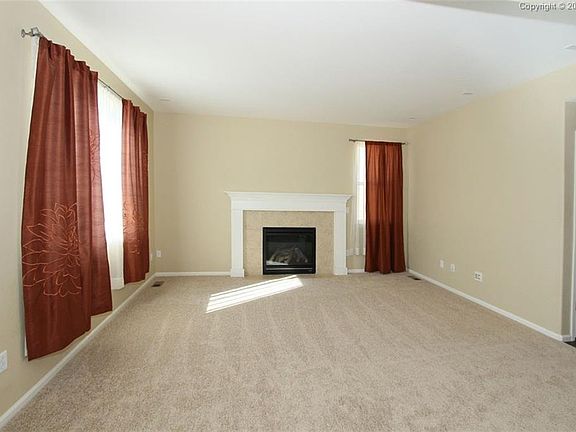 Newly carpeted Family room with gas fire place.