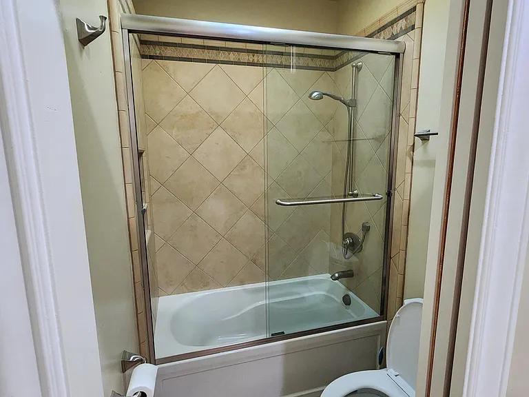 Guest Bathroom #1 with pocket door to private Toilet & Shower over Tub.