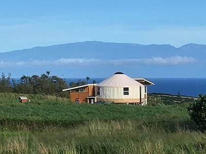 Rear view of yurt complex with Maui view. Bath house on left
