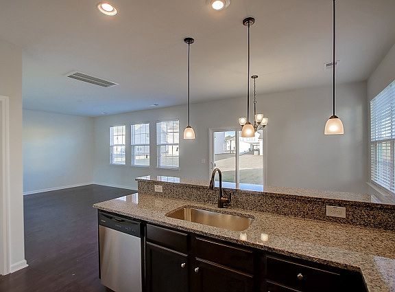Open kitchen with view of family room and backyard.
