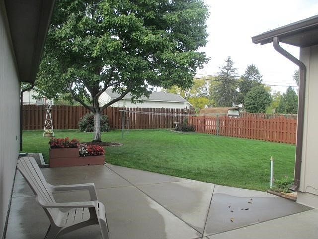 Beautifully landscaped backyard with fence, garden and shed.