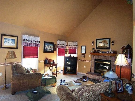 Earth tones and gas fireplace warm the living room
