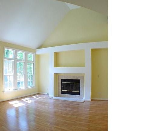 The Living Room, with a gas-log fireplace, transom windows & vaulted ceiling. 