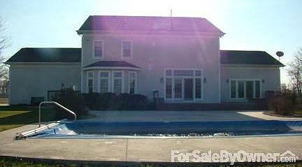 Pool / Back view
						:
						inground pool. Hot tub at right edge, on the deck, outside the master bedroom.