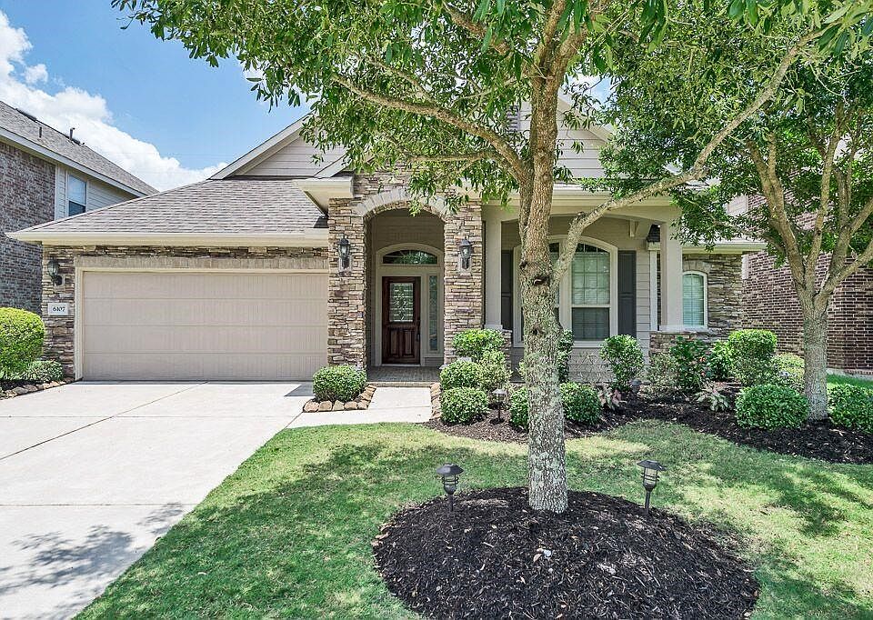 The stack stone elevation enhances the beautiful curb appeal of this home!