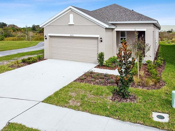 Flora new construction quick move-in open concept plan tuscan elevation front right angled view at B