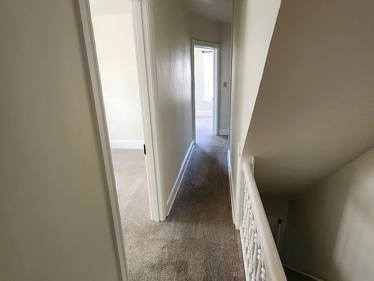 Hallway leading to living room and potential spare room/other living space or office.