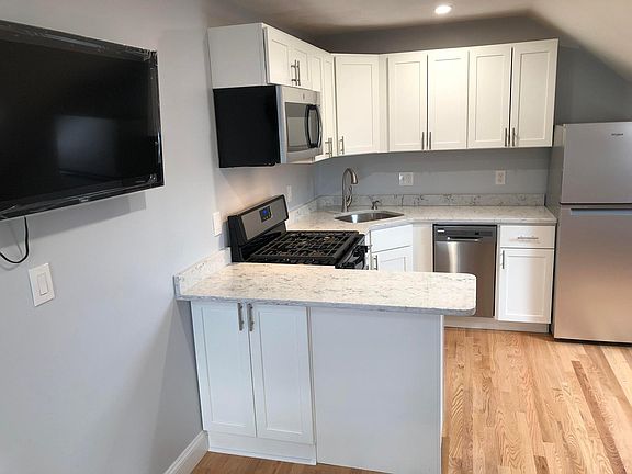 New eat in kitchen with new SS appliances including a fridge/freezer and a dishwasher, quartz counters and island. New LED lighting in all rooms and all have dimmer switches.