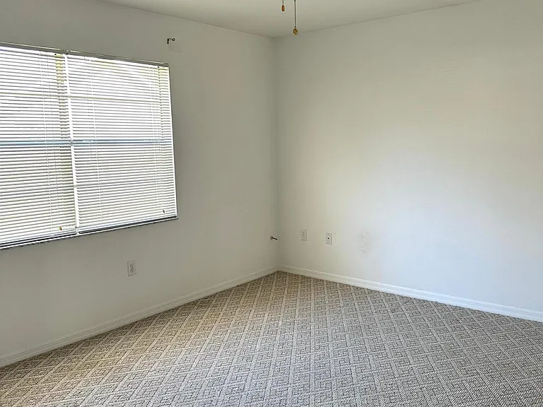 Bedroom #1 with ceiling fan and two closets.