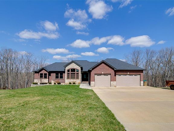 Beautifully landscaped, 3 car garage in front of home, level yard with additonal side drive