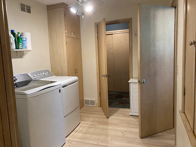 First floor laundry room with new appliances and storage built-ins and deep pantry