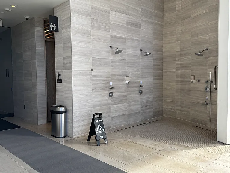 outdoor showers and restrooms next to hot tubs and pools